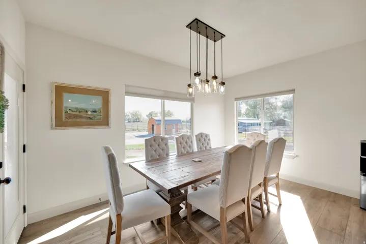 Dining space with wood-finish flooring and white walls