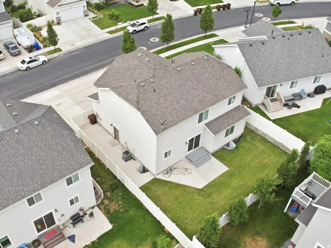 Aerial view of a residential neighborhood featuring multiple single-family homes with pitched roofs and attached garages