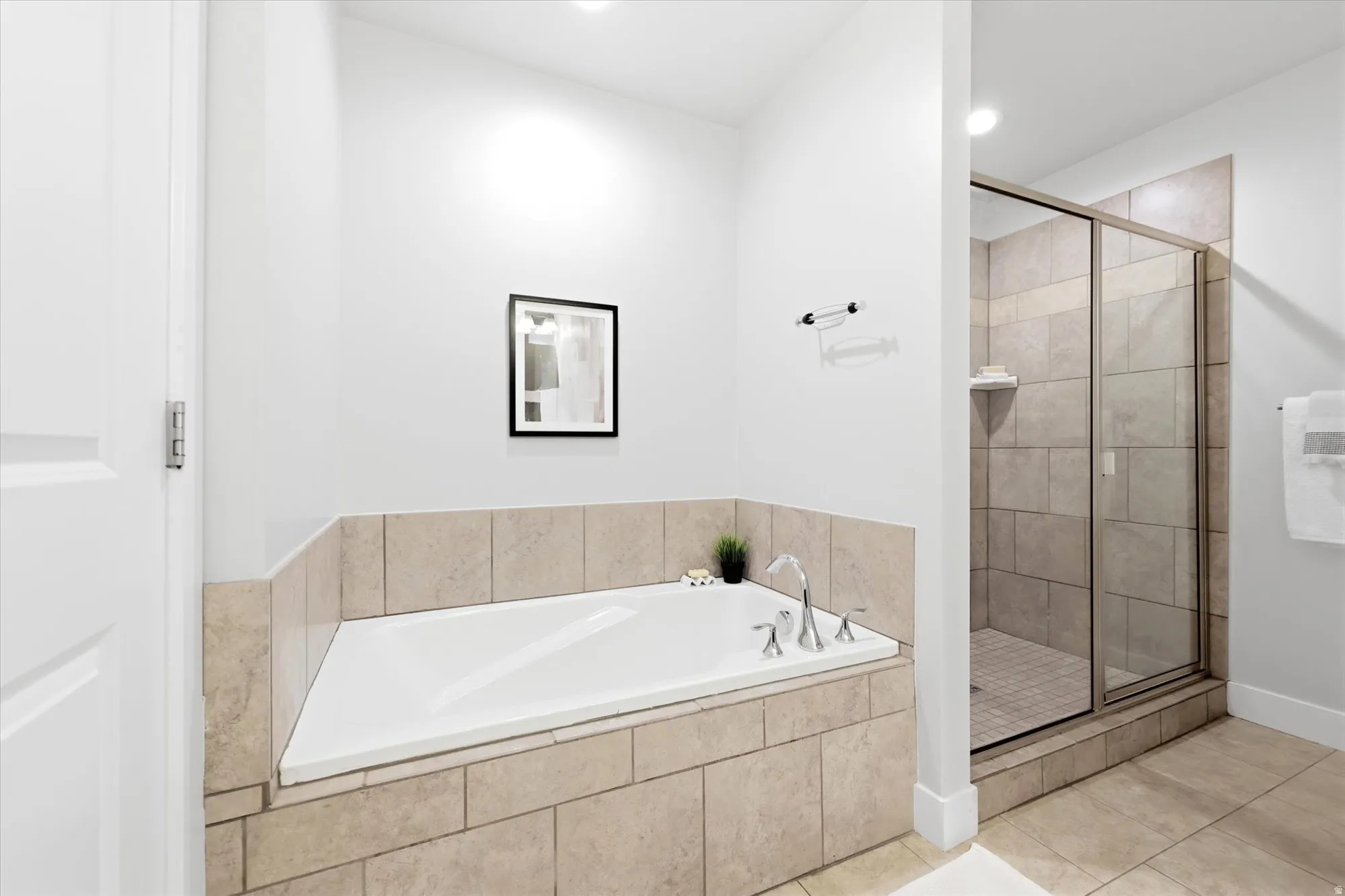 Soaking tub with a tiled surround and chrome fixtures