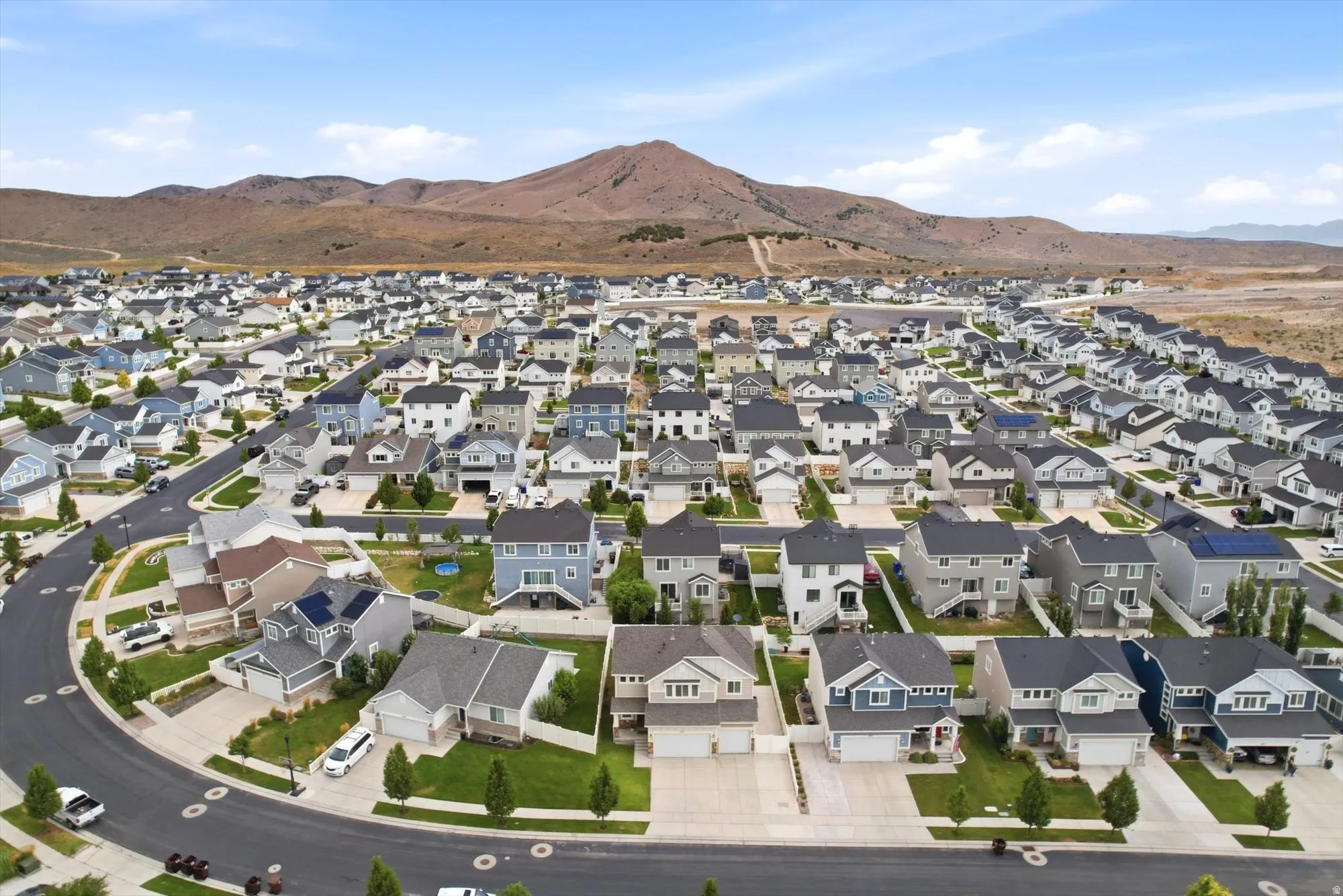 Expansive residential community with varied architectural styles, paved streets, and mature landscaping