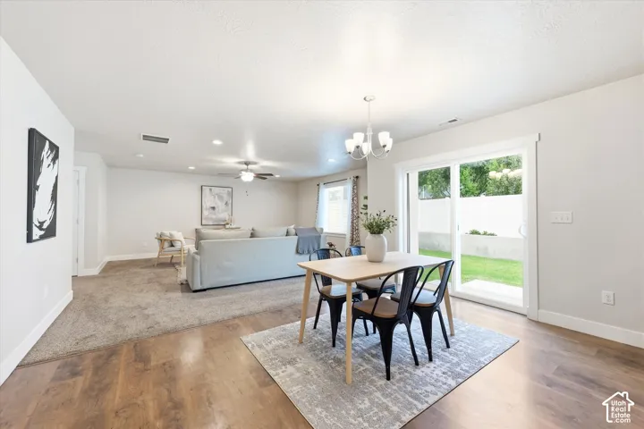 Spacious open-concept living area featuring wood-finish flooring, recessed lighting, and a ceiling fan