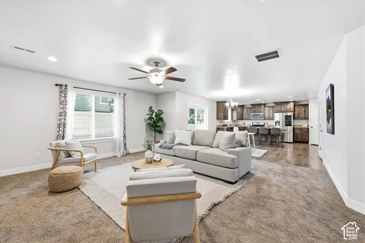 Expansive living area featuring carpeted flooring and recessed lighting