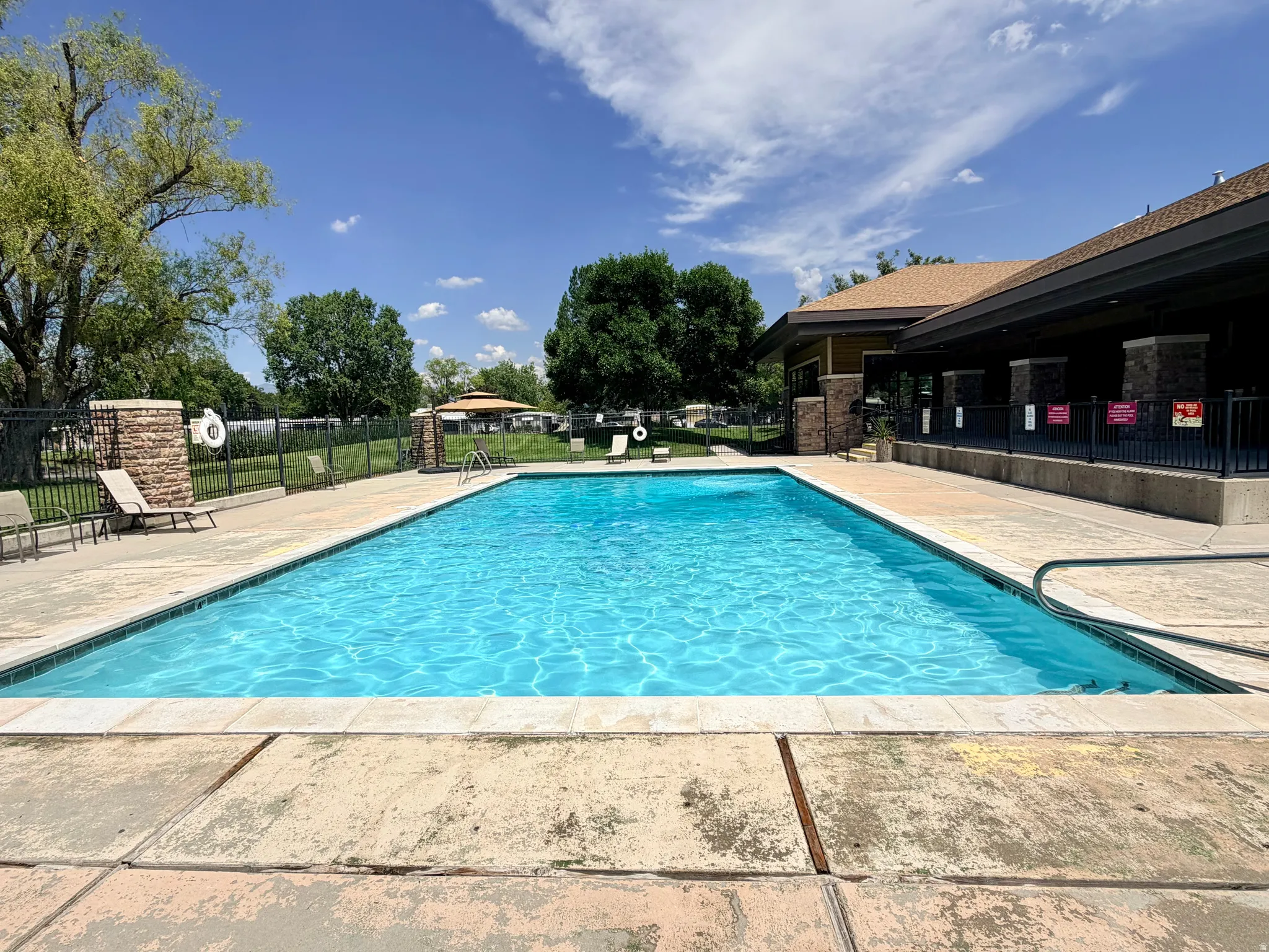 Rectangular outdoor swimming pool with surrounding concrete decking