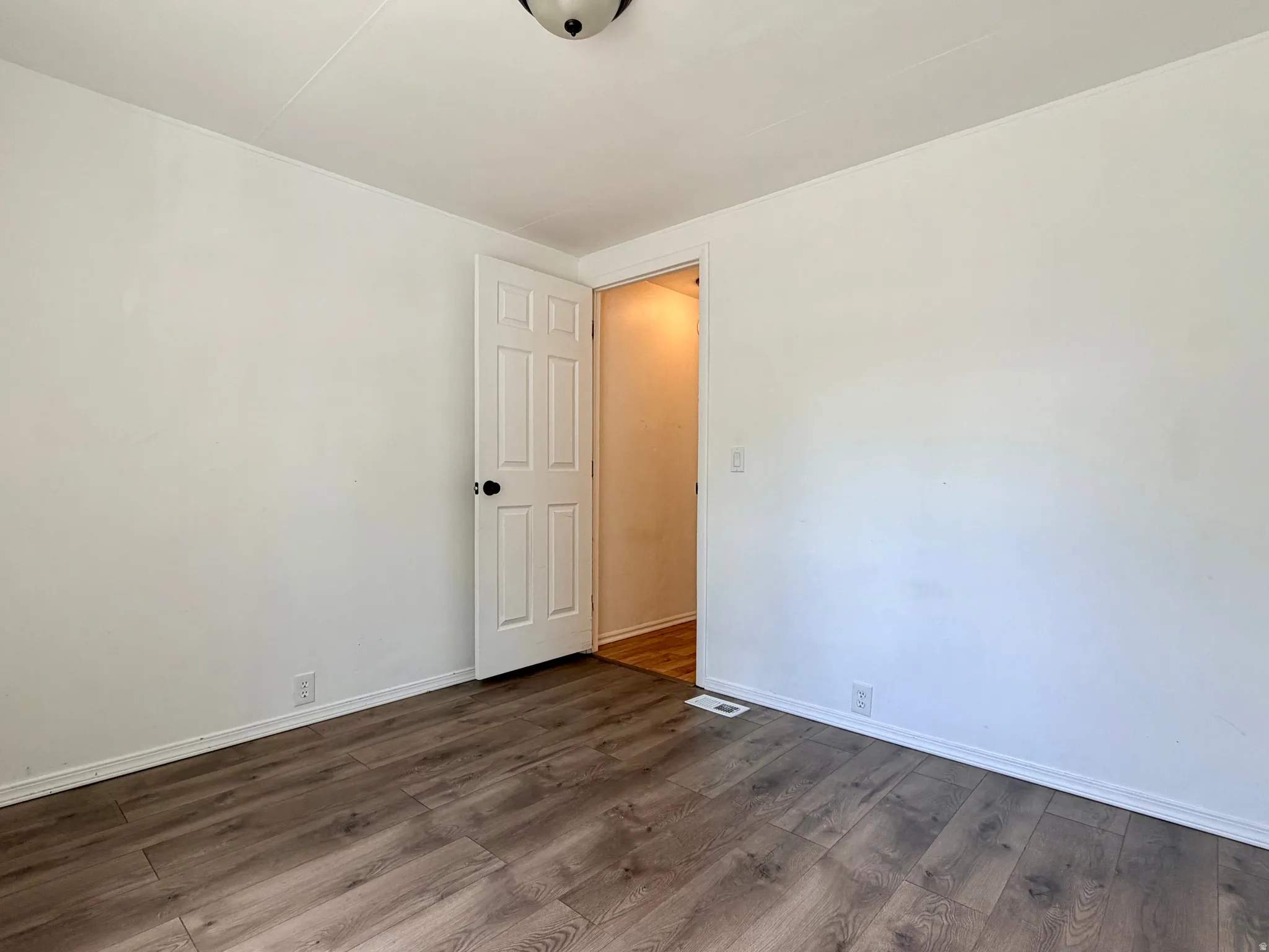 Neutral wall finishes, wood-finish flooring, and white trim
