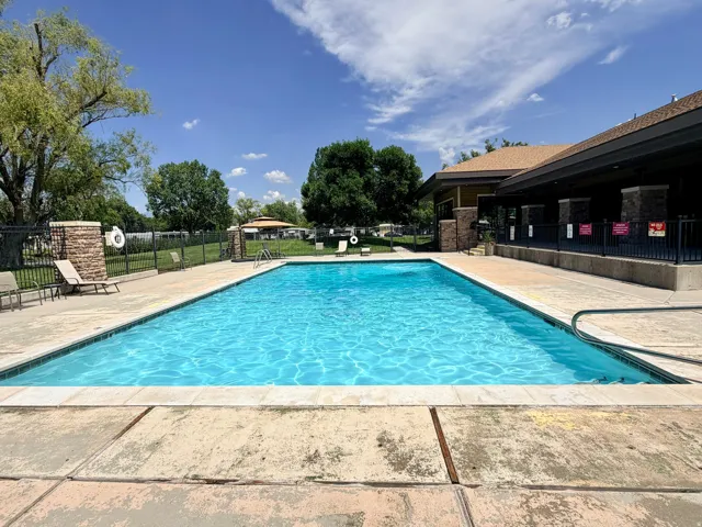 Rectangular outdoor swimming pool with surrounding concrete decking