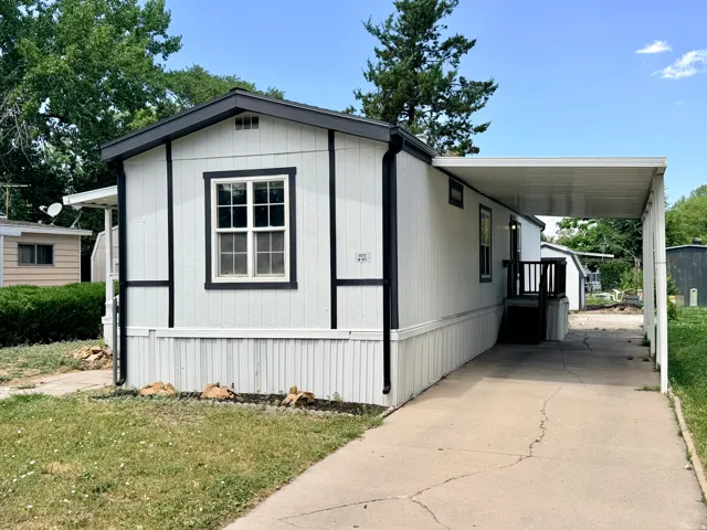 White exterior with black trim and a dark roofline
