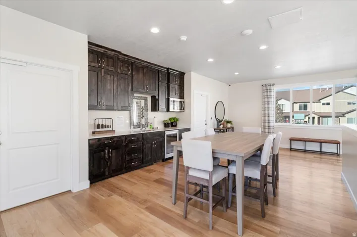Brightly lit living space featuring wood-finish flooring