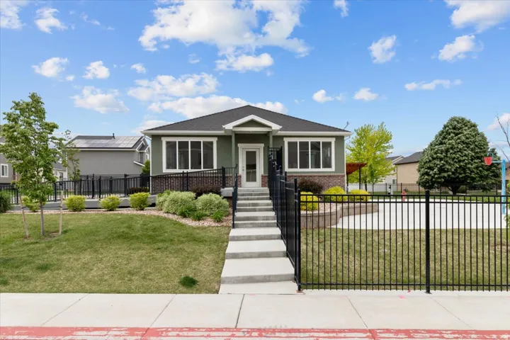 Contemporary single-story residence with a dark green facade and white trim accents
