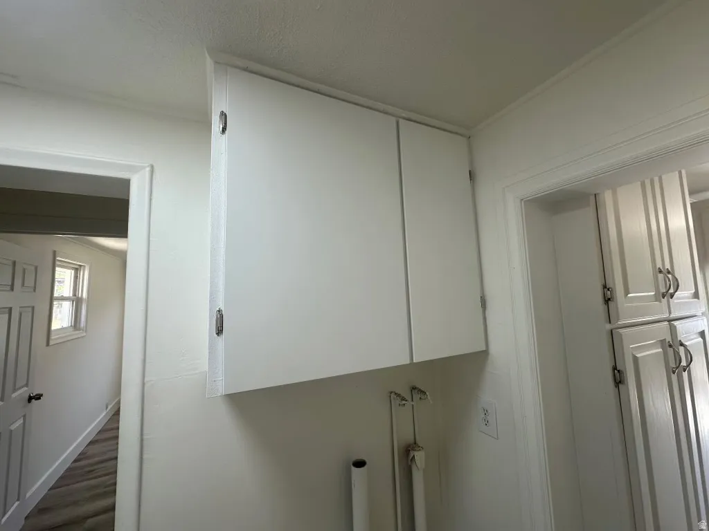 White upper cabinetry with recessed panel doors and brushed nickel hardware