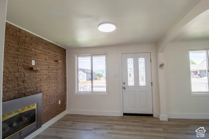 Living area featuring a brown brick accent wall with a built-in fireplace