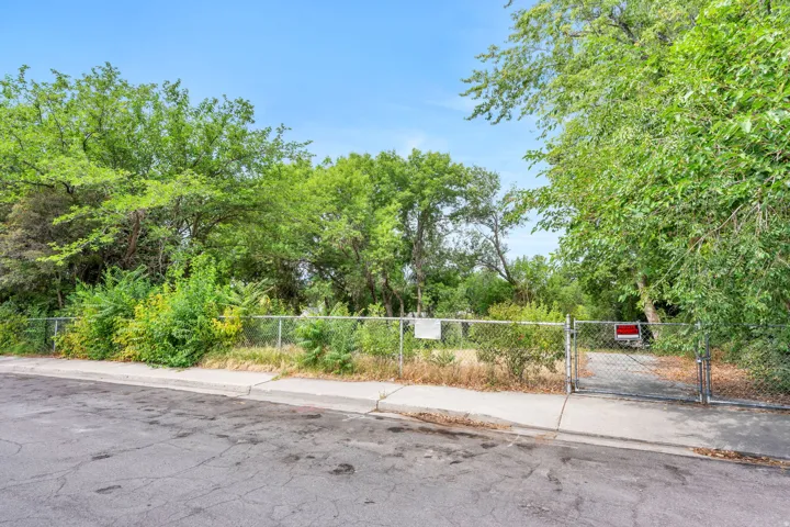 Gated lot featuring mature trees and established perimeter fencing