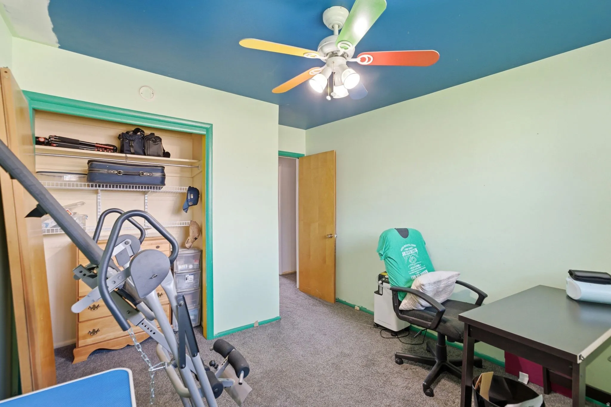 Room featuring light green walls, and gray carpet flooring