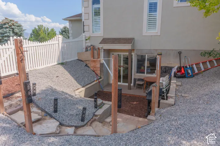 Terraced exterior landscaping featuring gravel and wood chip ground cover