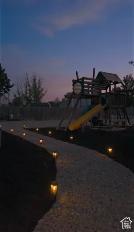 Gravel pathway with integrated pathway lighting and dark mulch