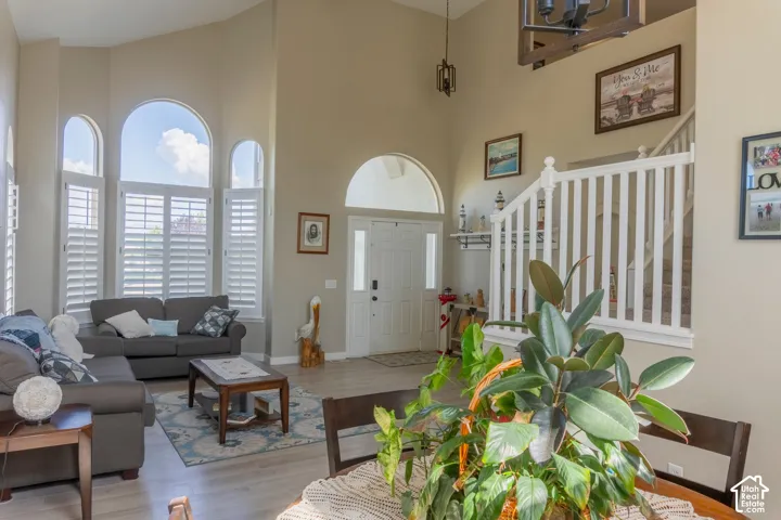 Two-story living area featuring vaulted ceilings and extensive arched windows with plantation shutters