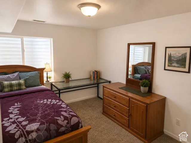 Spacious interior with neutral wall tones and plush carpeting