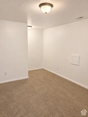 Neutral-toned carpet flooring complementing white walls and ceiling