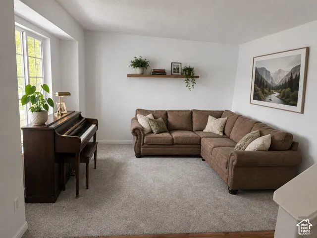 Light gray wall-to-wall carpeting complements bright white walls. Decor digitally added.