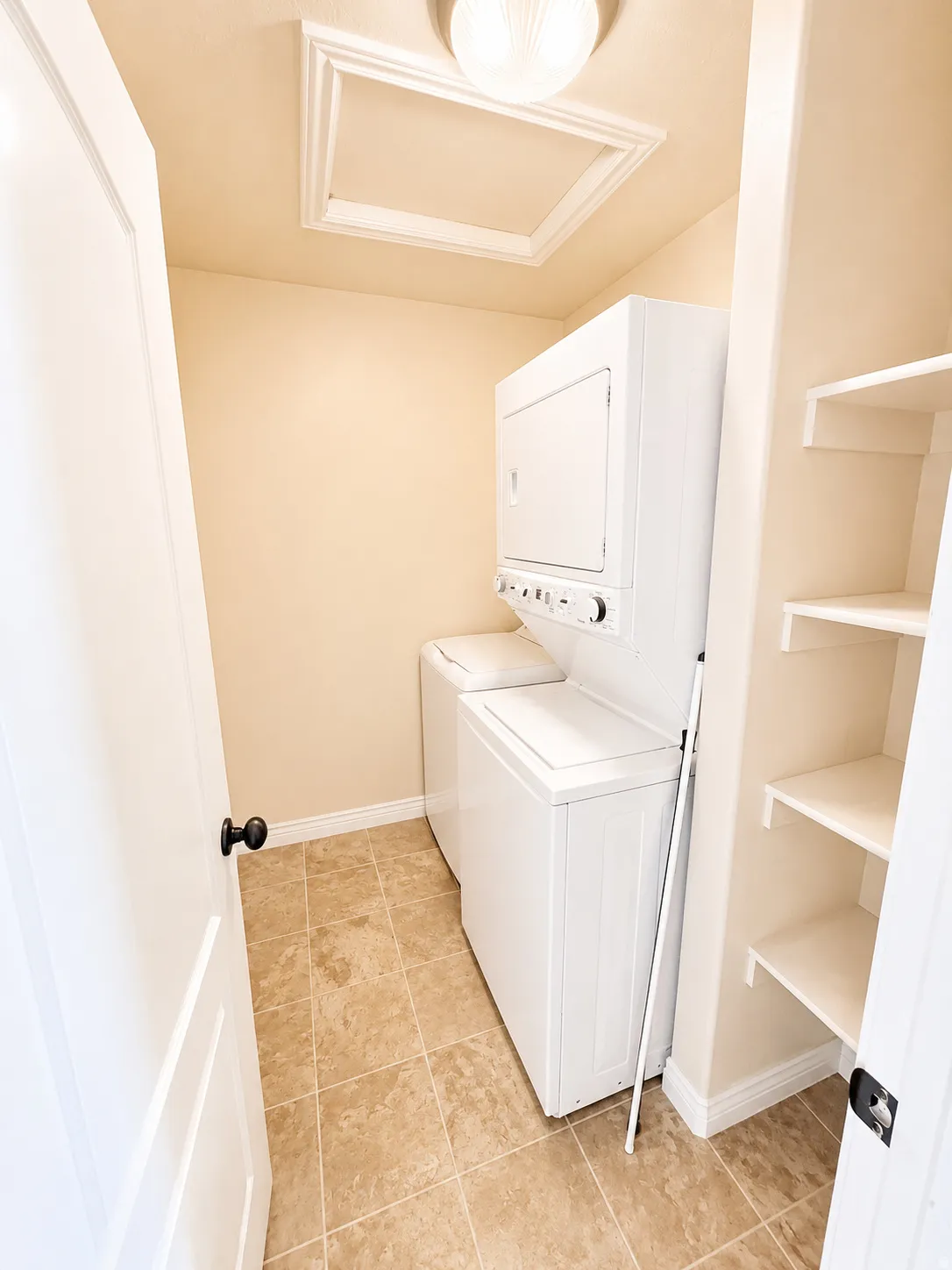 Dedicated laundry area featuring neutral-toned floor tile and light-colored walls