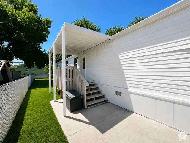 Covered patio with a concrete slab-Grass has been altered. Owners are practicing drought guidelines.