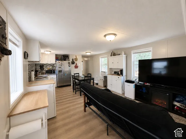 Open-concept living space featuring wood-finish flooring
