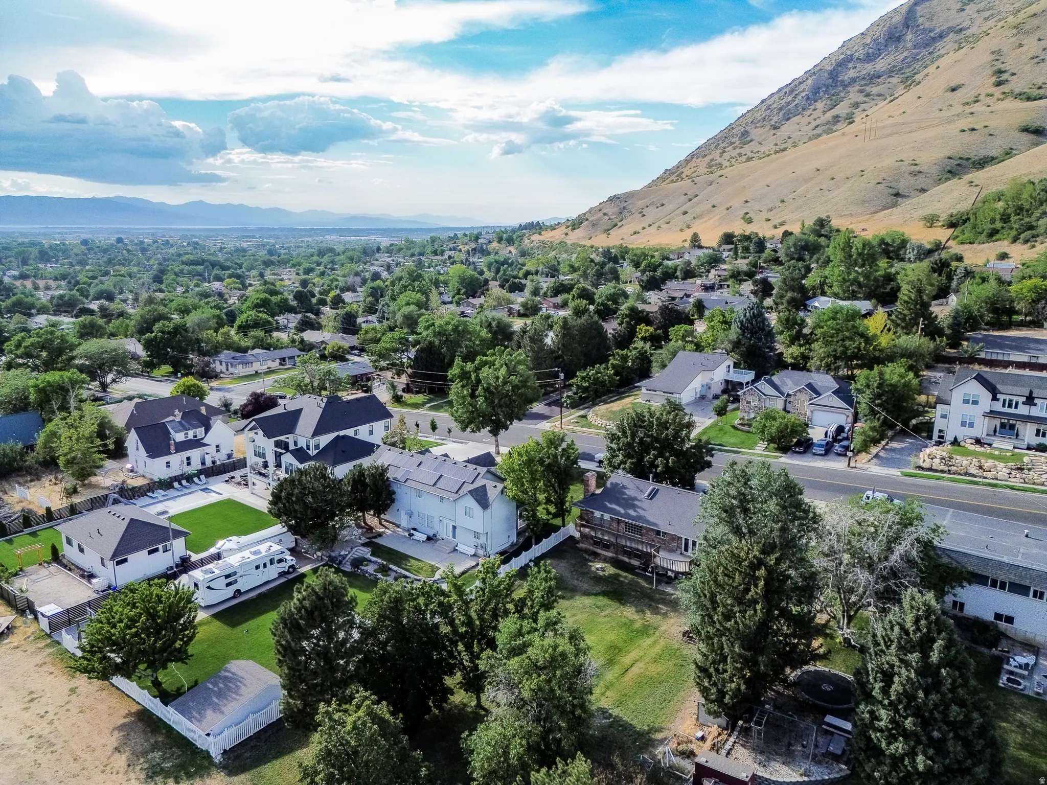 Aerial perspective showcasing a residential neighborhood with varied architectural styles and mature landscaping