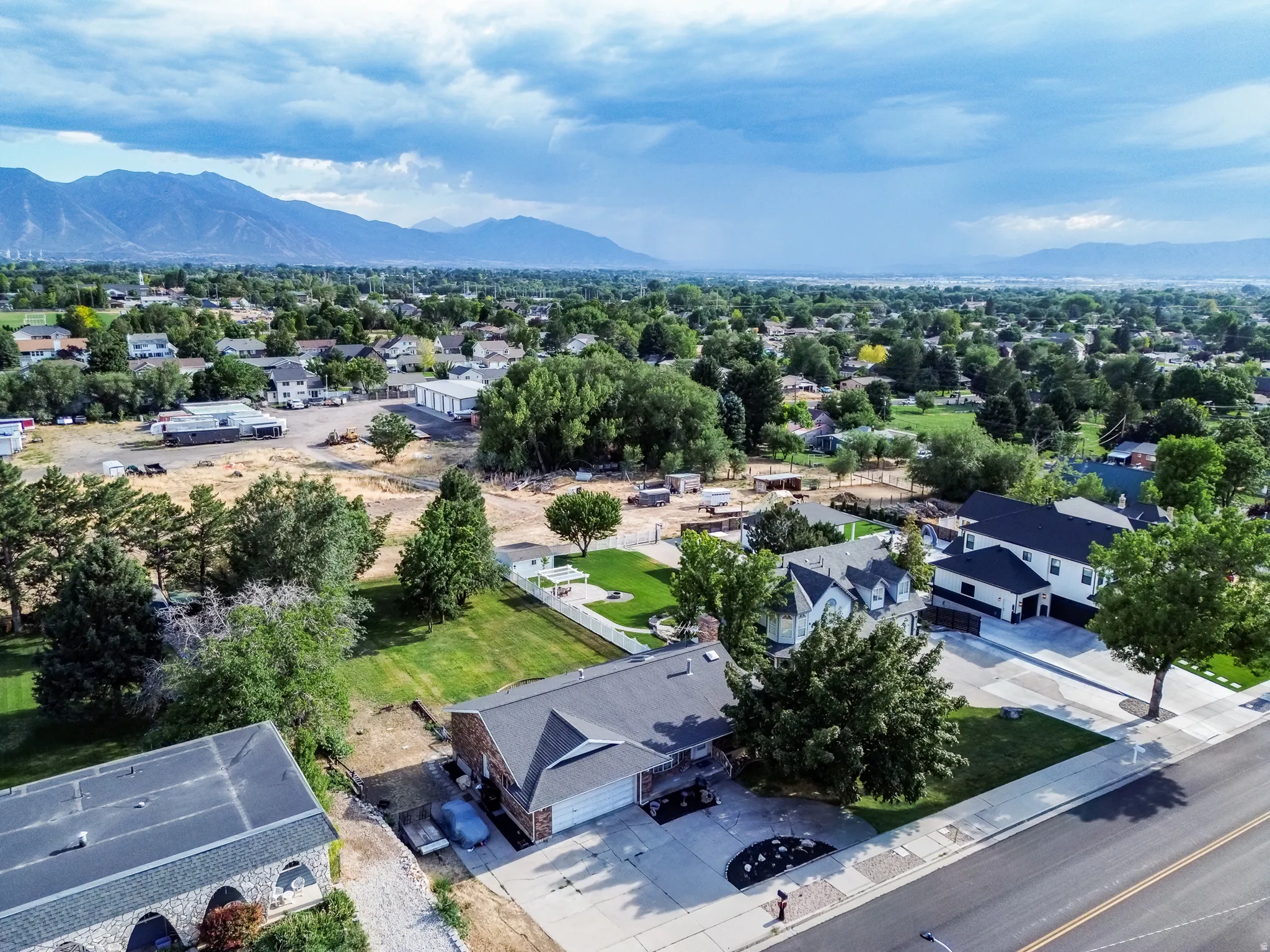 Aerial perspective showcasing a residential street with mountain scenery