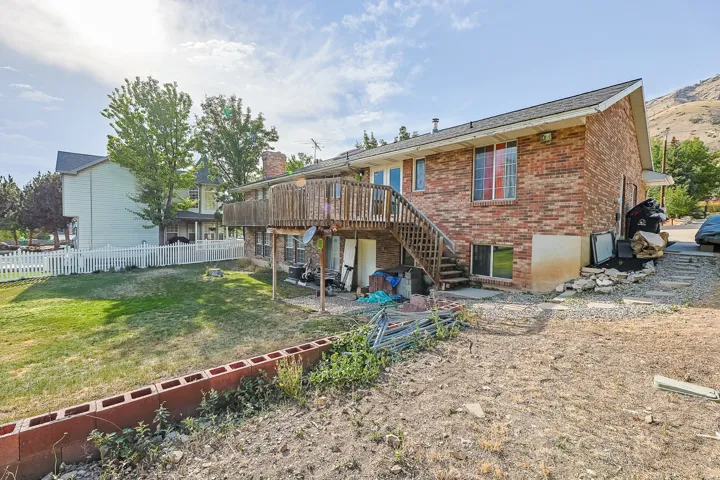 Brick exterior with a wooden deck and staircase
