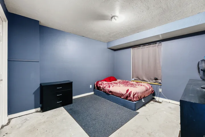 Room featuring painted blue walls and a textured ceiling