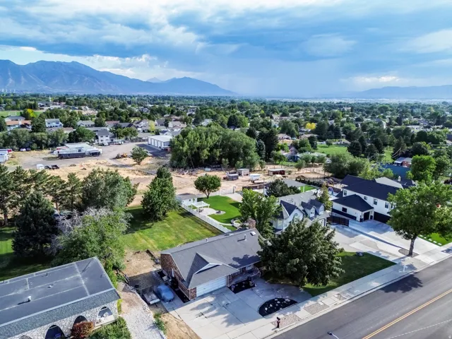 Aerial perspective showcasing a residential street with mountain scenery