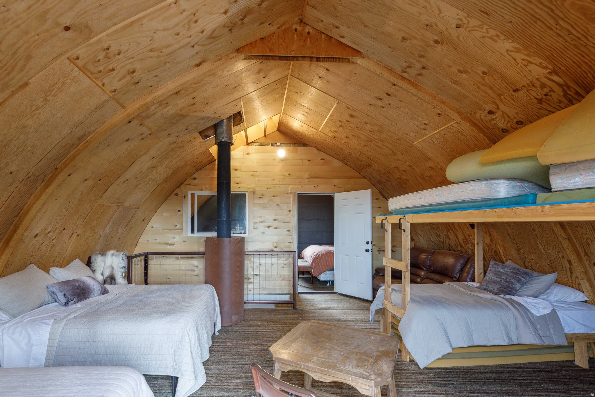 Vaulted wood-paneled ceiling with exposed beams