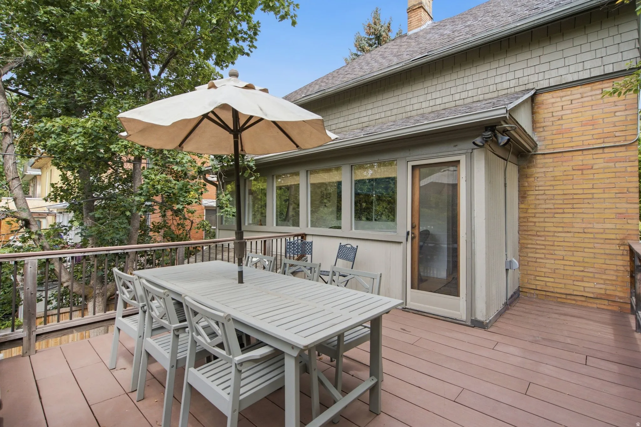 Spacious outdoor deck featuring brown composite decking and wood railings
