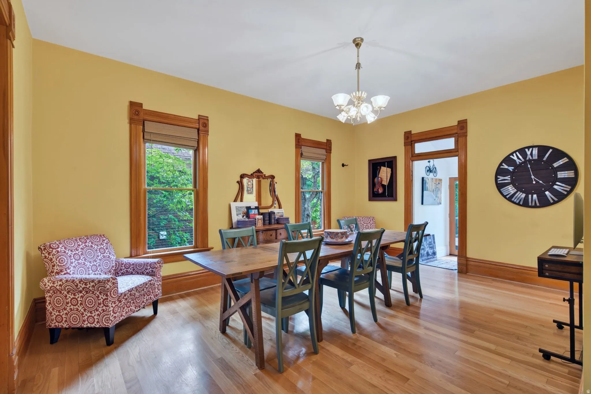 Dining area featuring rich wood-finish flooring and substantial wood trim