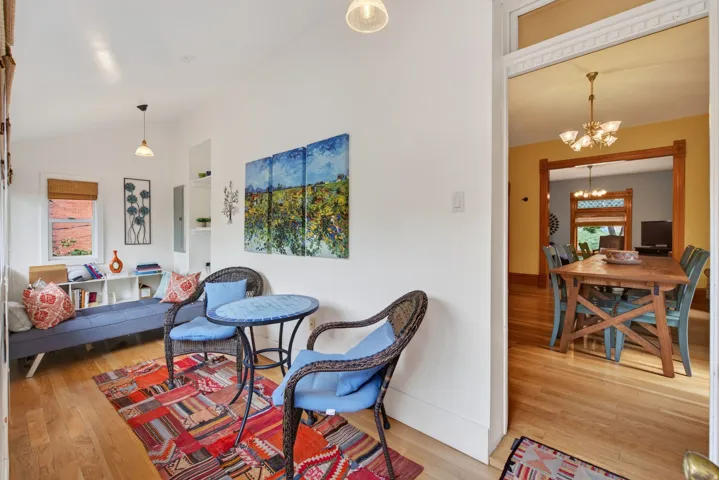 Hardwood flooring extending throughout the living space and into the dining area