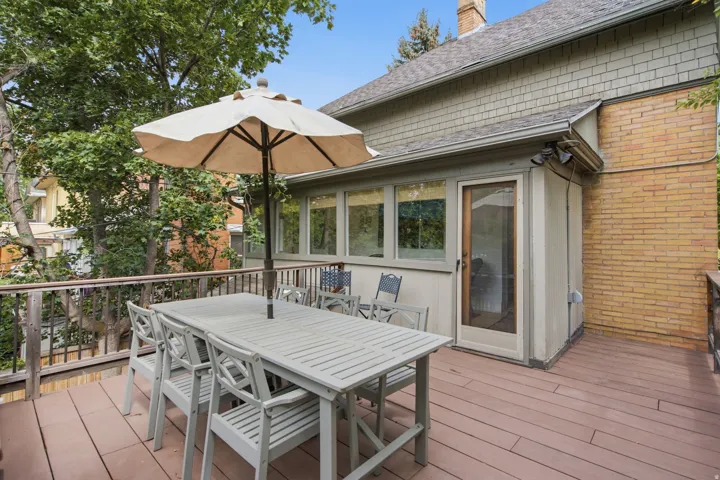 Spacious outdoor deck featuring brown composite decking and wood railings