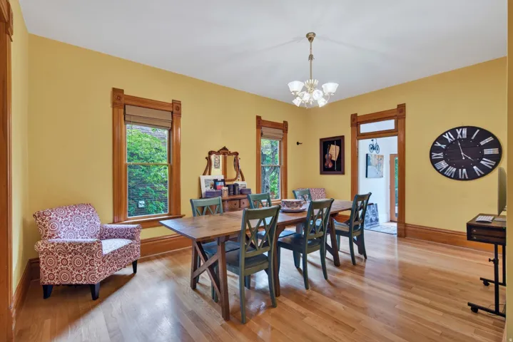 Dining area featuring rich wood-finish flooring and substantial wood trim