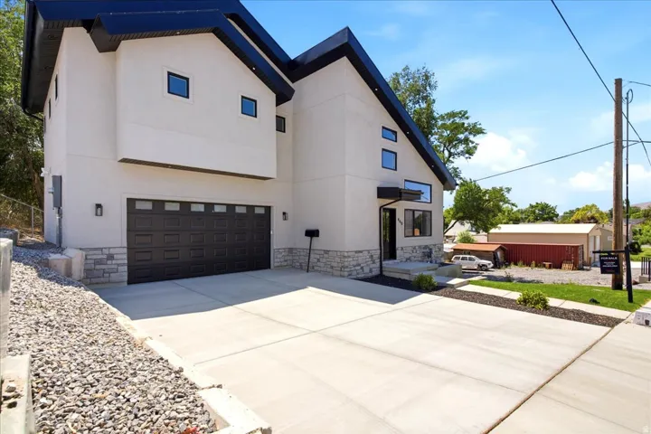 Contemporary stucco exterior with a striking dark roofline