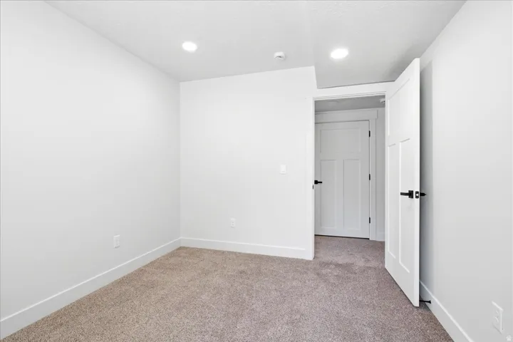 Neutral-toned carpeting paired with bright white walls