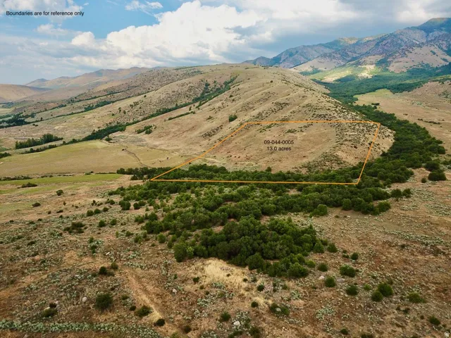 Expansive 13.0-acre property featuring diverse topography with hillsides and flat areas