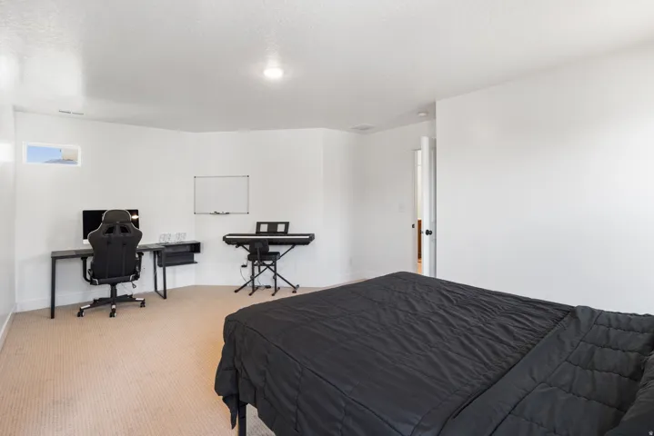 Carpeted room featuring crisp white walls and ceiling