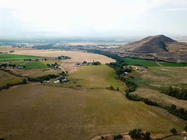 Expansive rural landscape featuring a mix of cultivated fields and rolling natural terrain
