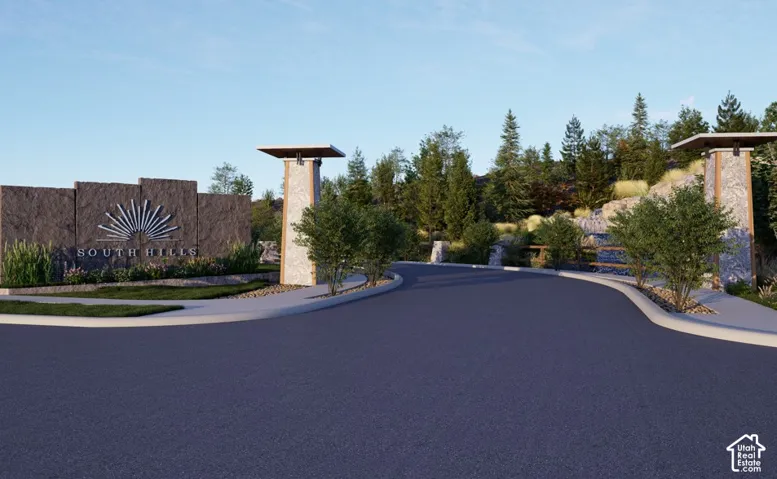 Entryway featuring a prominent stone monument with "SOUTH HILLS" engraving, flanked by decorative pillars and lush landscaping