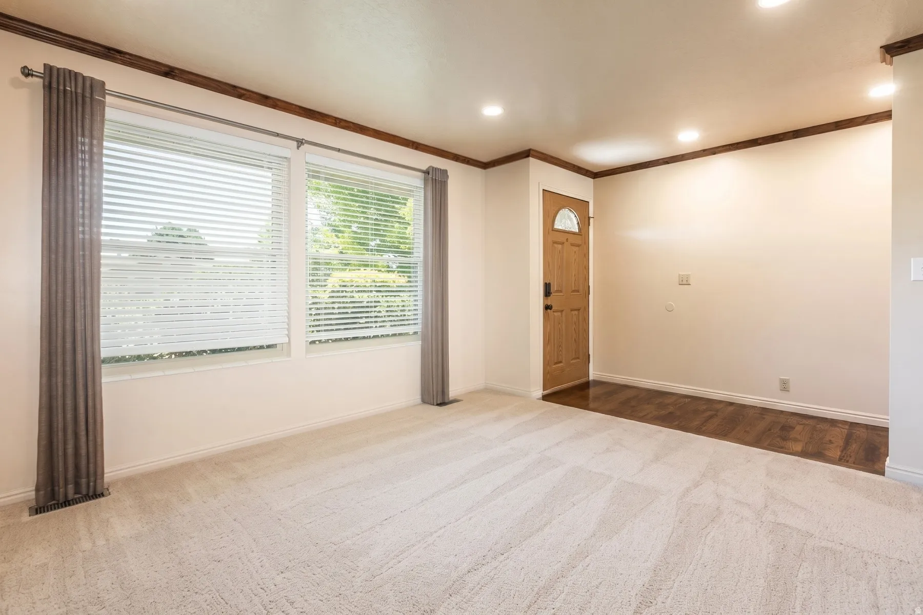 Inviting entryway with rich wood flooring.