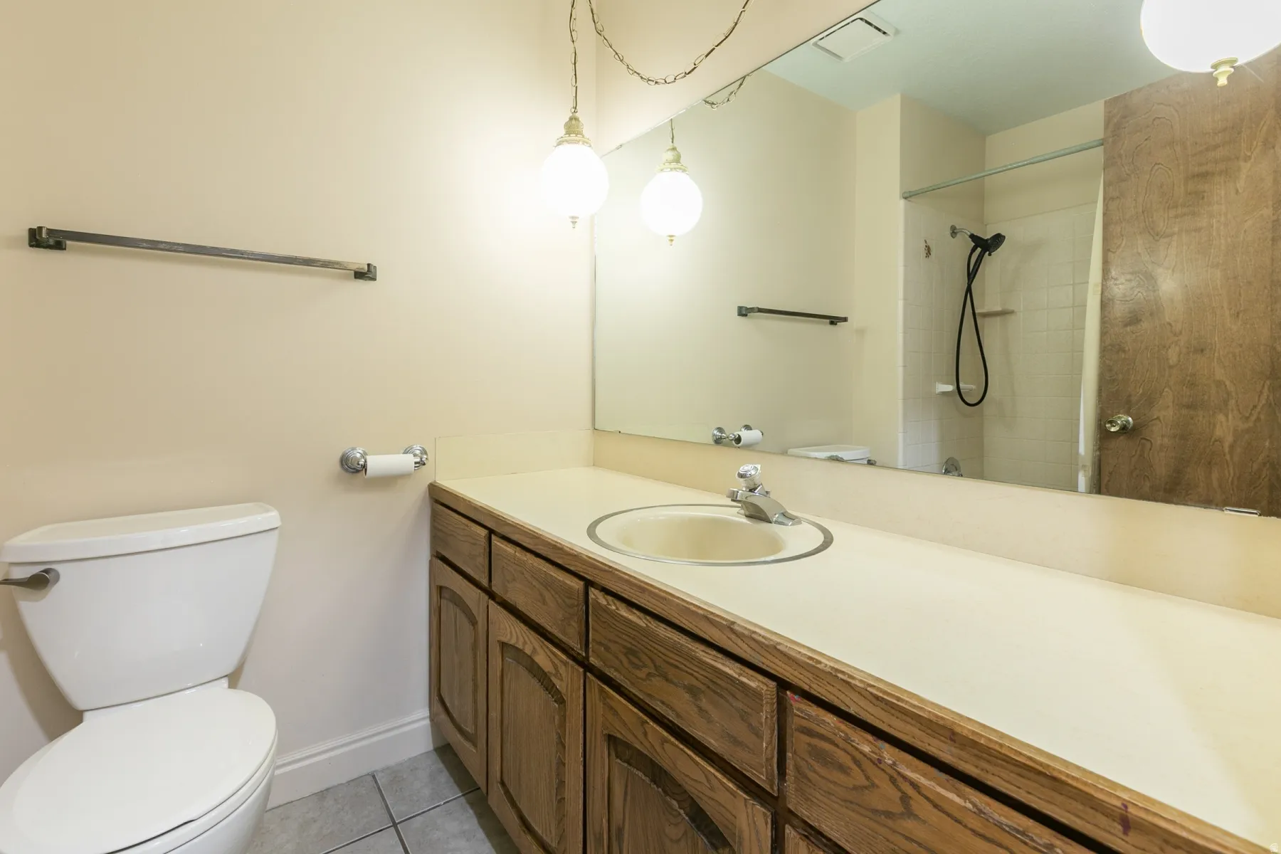 Main floor bathroom with tub/shower and long vanity.