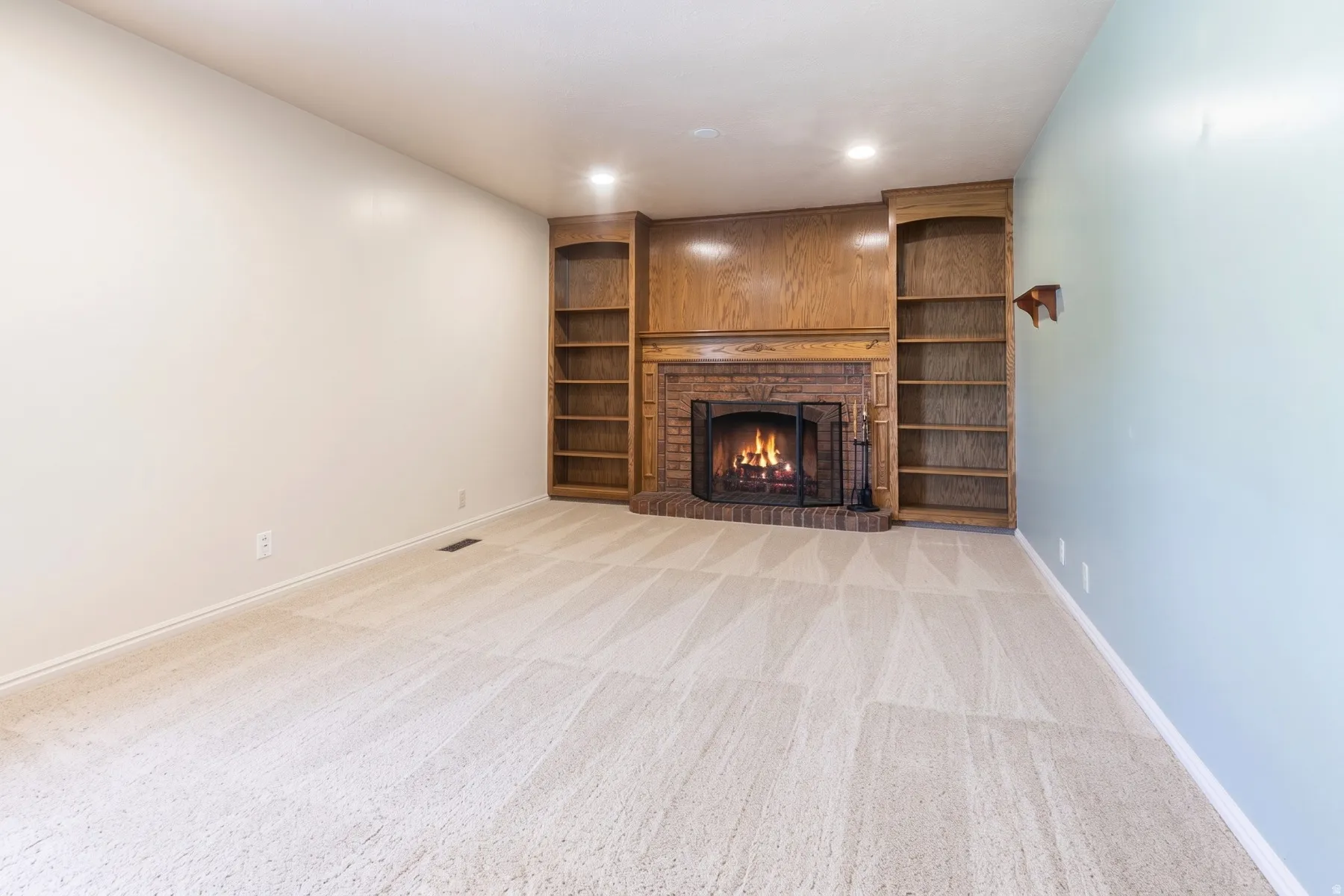 Built in shelving in family room with cozy fireplace.