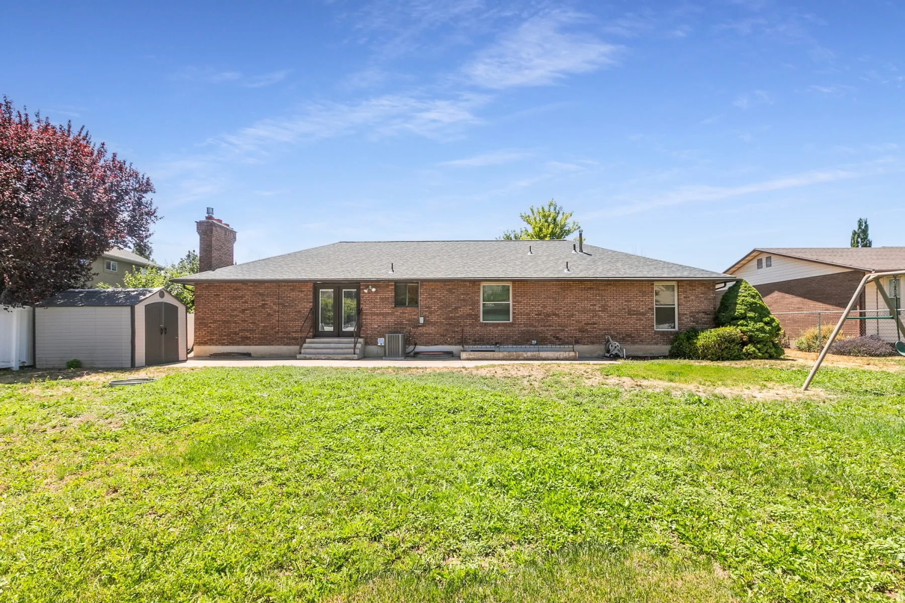 This all brick rambler has a wonderful flat yard!