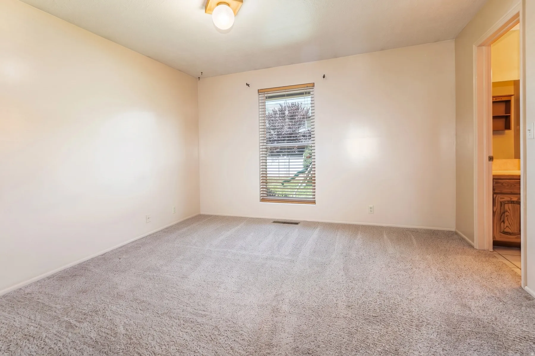 Primary suite with private 3/4 bath and walk in closet.