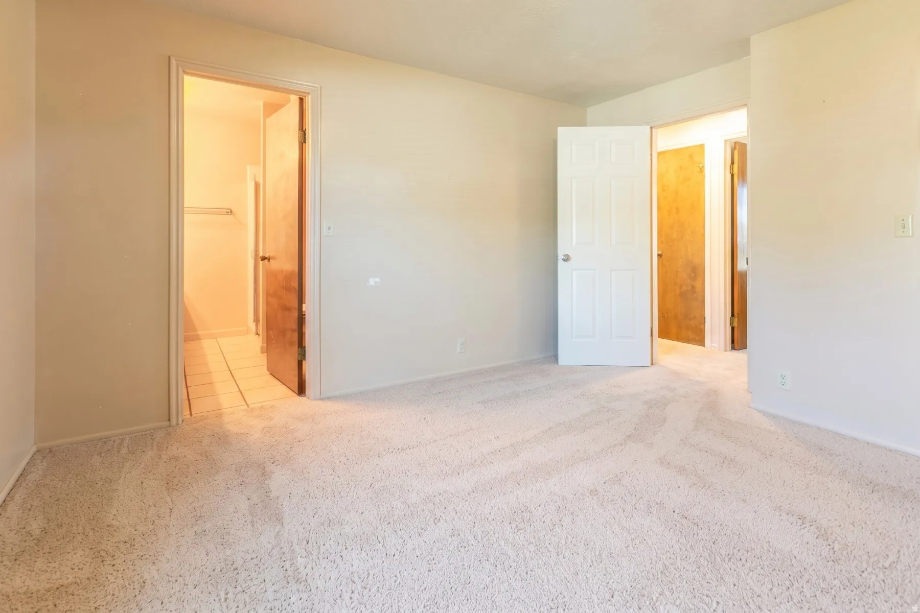 Primary bedroom view to bath and hall.