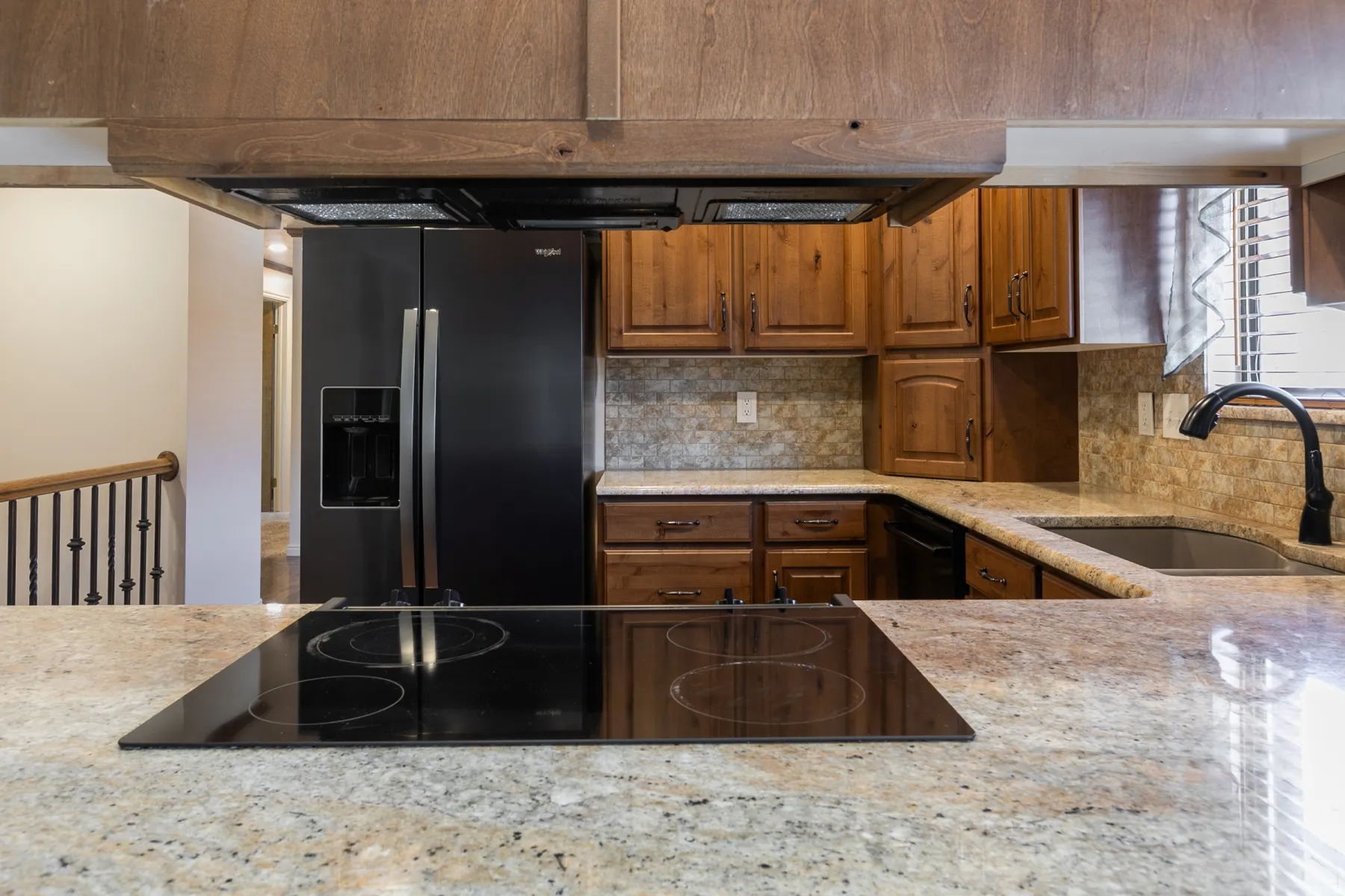 Updated kitchen with beautiful cabinetry and granite counter tops.