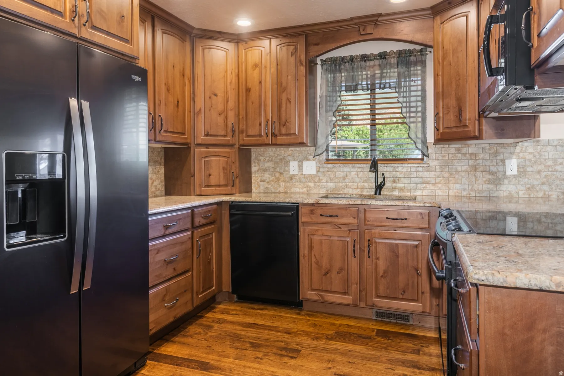 Updated kitchen with beautiful cabinetry and granite counter tops.